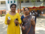 CHENNAI, APR 19 (UNI):- Voters showing a mark of indelible ink after casting their votes at a polling booth during the 1st Phase of General Elections-2024 at Chennai Girls Higher Secondary School in Nungambakkam at Chennai, in Tamil Nadu on Friday. UNI PHOTO-286U