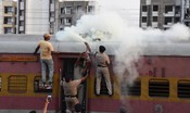 RANCHI,MAR 14 (UNI):-Railway Police Force personnel use a fire extinguisher to rescue an unidentified man who was electrocuted atop the Ranchi–Anand Vihar Passenger Express after touching a high-tension wire at Ranchi Railway Station on Saturday.UNI PHOTO-108U