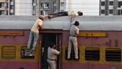 RANCHI,MAR 14 (UNI):-Railway Police Force personnel use a fire extinguisher to rescue an unidentified man who was electrocuted atop the Ranchi–Anand Vihar Passenger Express after touching a high-tension wire at Ranchi Railway Station on Saturday.UNI PHOTO-109U